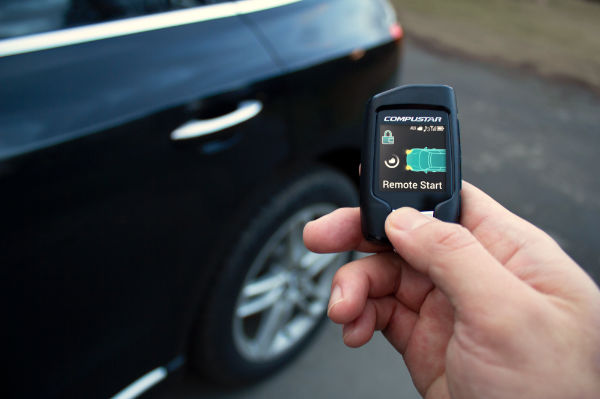 person using remote start key fob